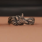 Oxidized silver fox head ring on a brown background